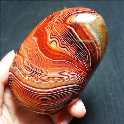An orange, yellow, and brown stone with stripes